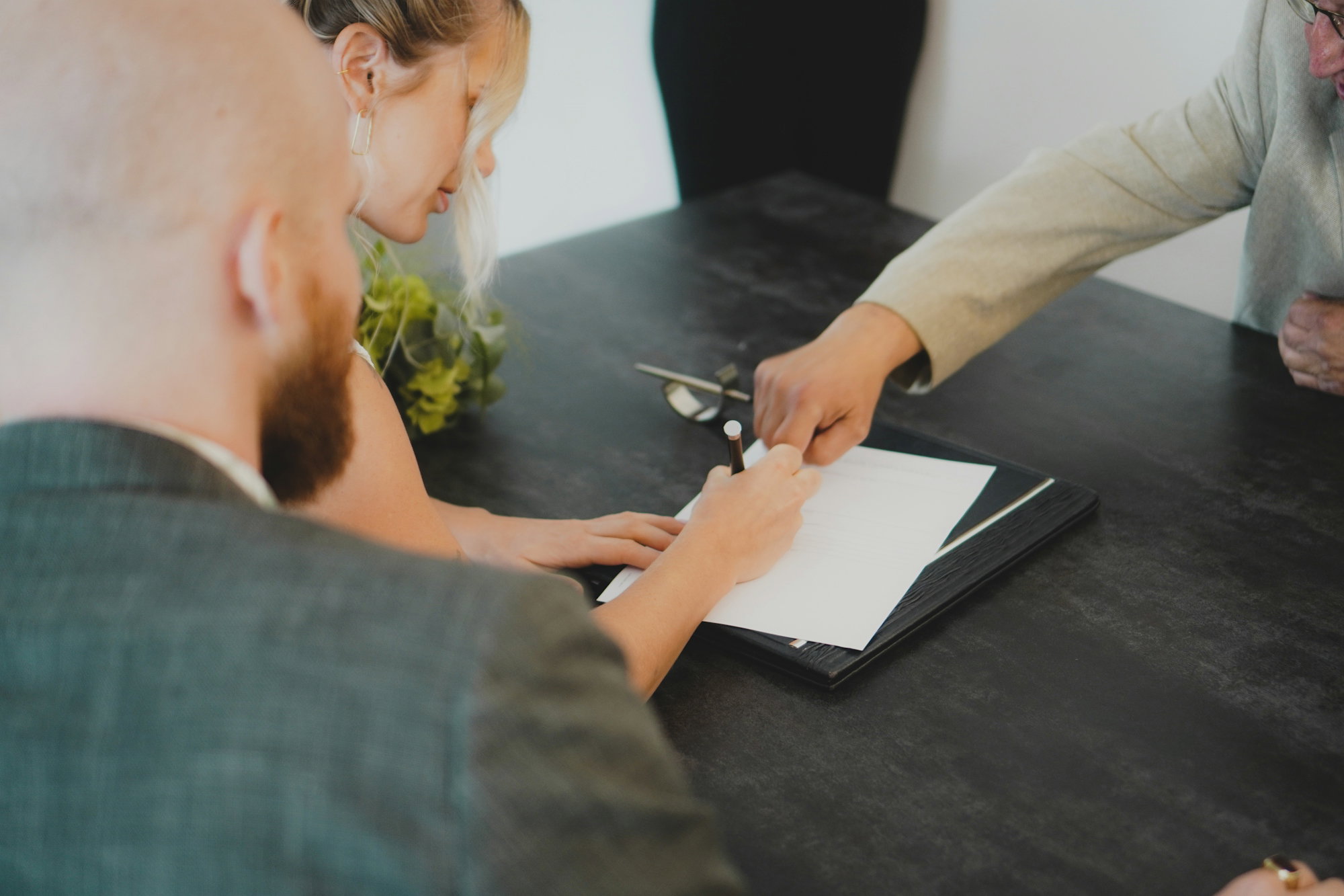 couple-signing-document-at-desk.jpg couple signing document at desk